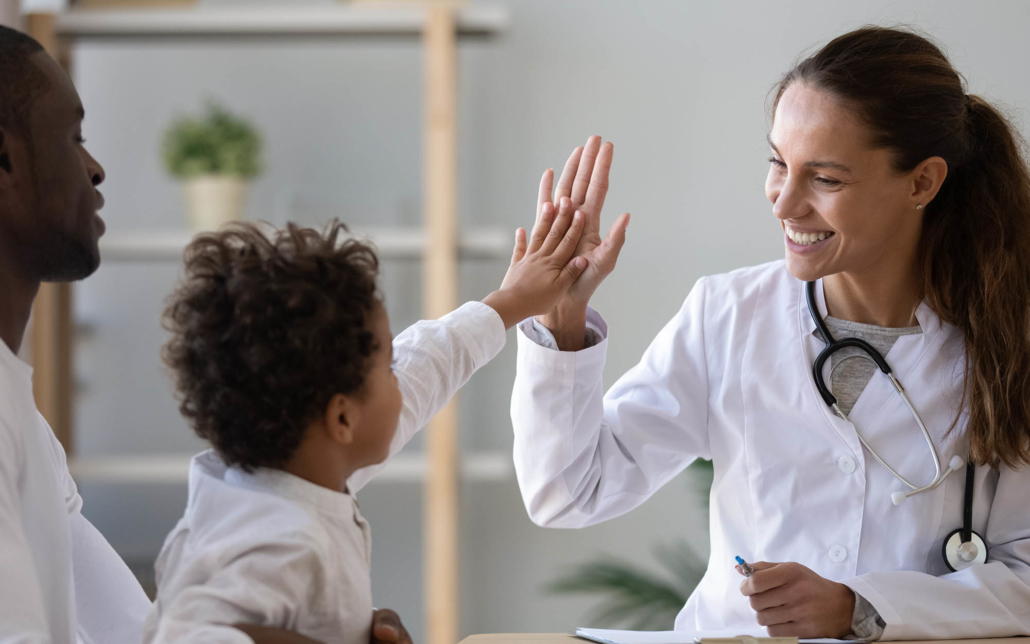 Medical person high fiving a child patient