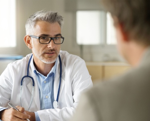 Front view of a physician speaking with a patient