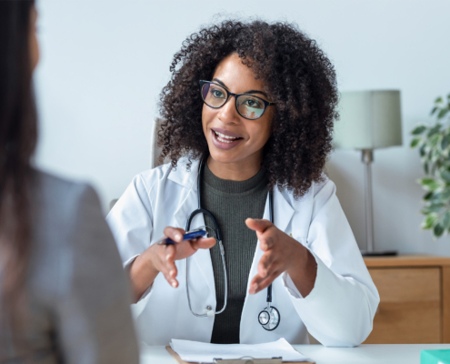 Front view of female doctor talking to other woman