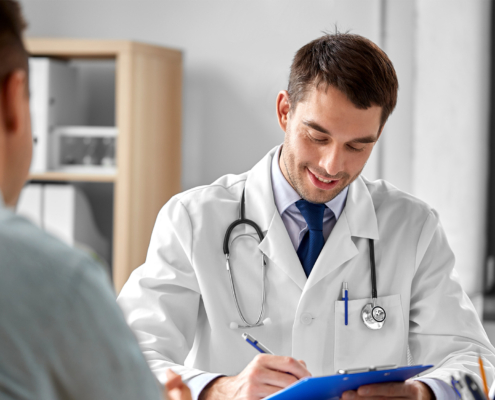 medicine, healthcare and people concept - doctor with clipboard